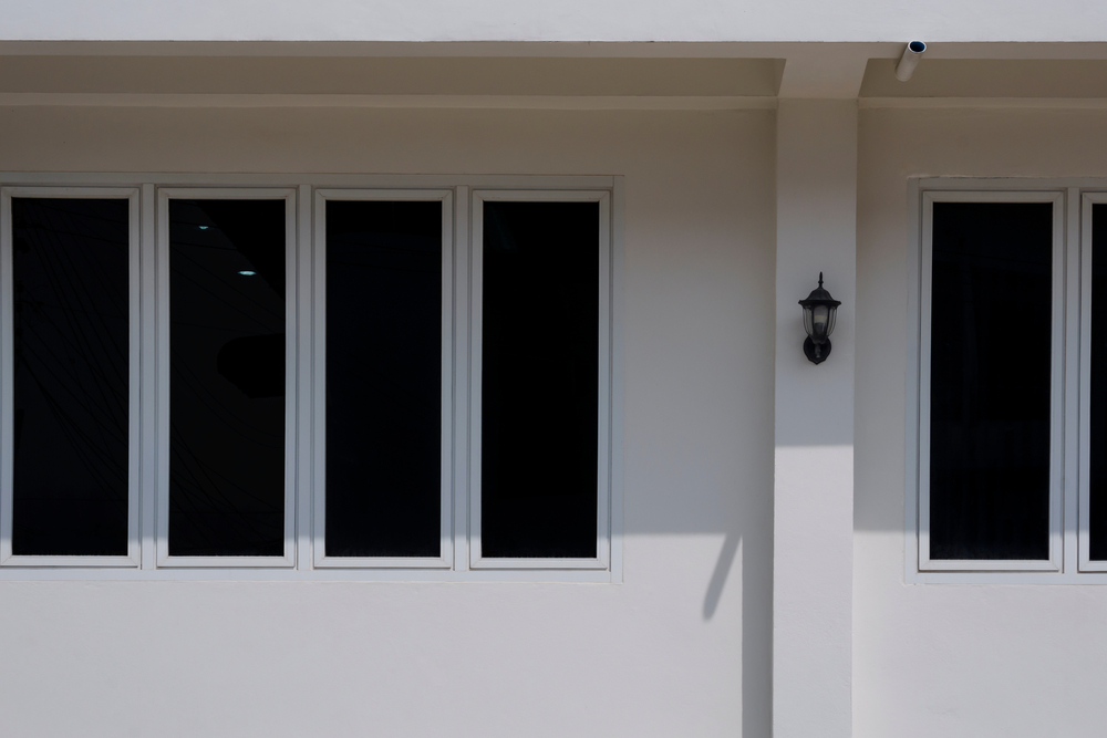 Sunlight,And,Shadow,On,Glass,Windows,Surface,Outside,Of,House